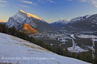 Stock photo of the Town of Banff viewed from Norquay Meadow along Mount Norquay Road during winter after snow fall with Mount Rundle (2949 metres/9675 feet) and Tunnel Mountain (1692 metres/5551 feet) to the left, Banff National Park.