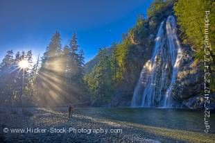 Stock photo of couple enjoying mountain view and water falls of Virgin Falls, Tofino Creek, Vancouver Island, British Columbia.
