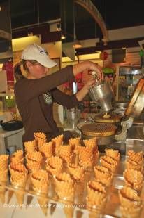 Stock photo of a young woman making waffle cones for ice cream desserts at a store (Cow's) in the town of Niagara-on-the-Lake, Ontario, Canada.
