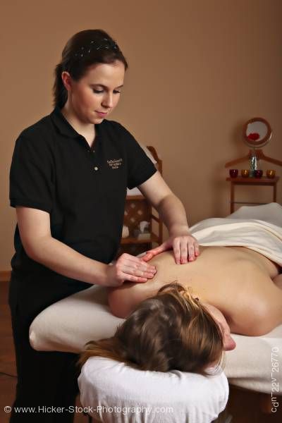 Stock photo of Masseuse giving body massage to female