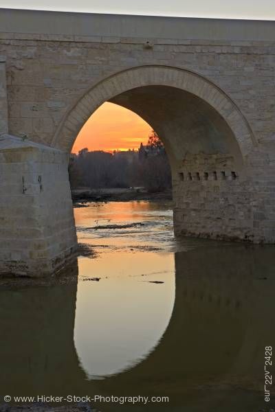 Stock photo of Puente Romano spans Rio Guadalquivir at sunset in city of Cordoba Province of Cordoba Andalusia
