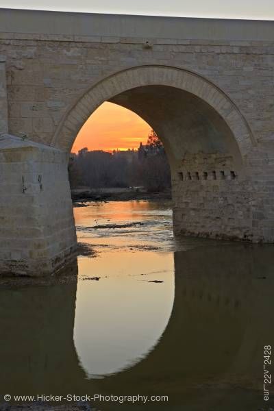 Stock photo of Puente Romano spans Rio Guadalquivir at sunset in city of Cordoba Province of Cordoba Andalusia
