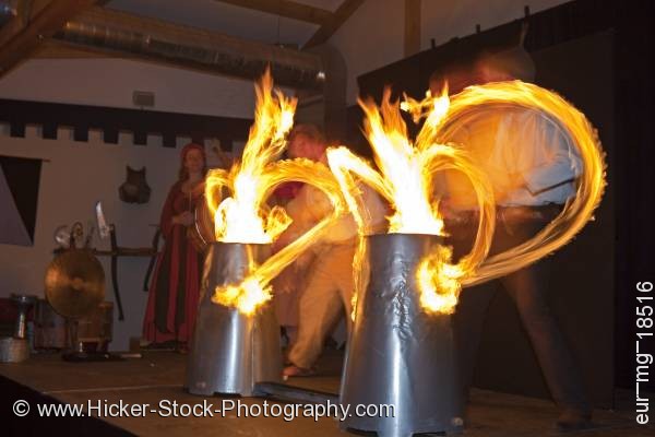 Stock photo of Entertainers drumsticks lit by fire medieval feast