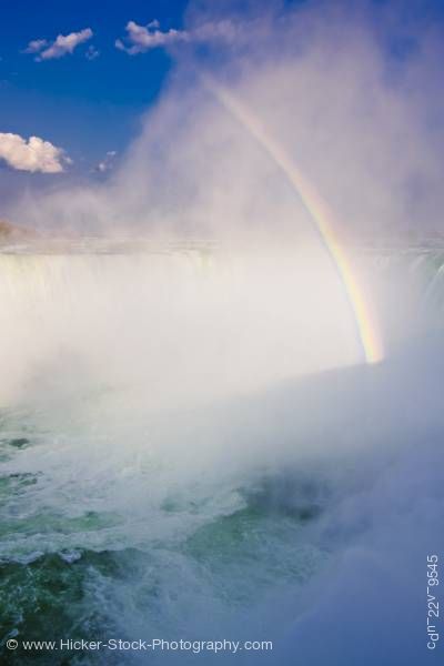 Stock photo of Horseshoe Falls Rainbow Mist Niagara River Niagara Falls Ontario Canada Blue Sky
