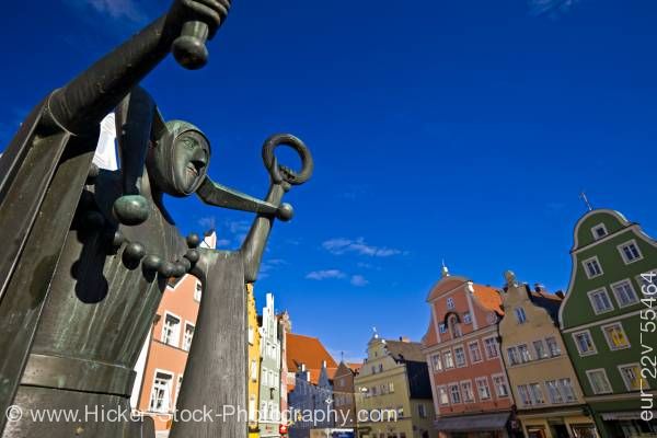 Stock photo of Bronze statue of jester back dropped by colorful facades of buildings in Old Town district Landshut