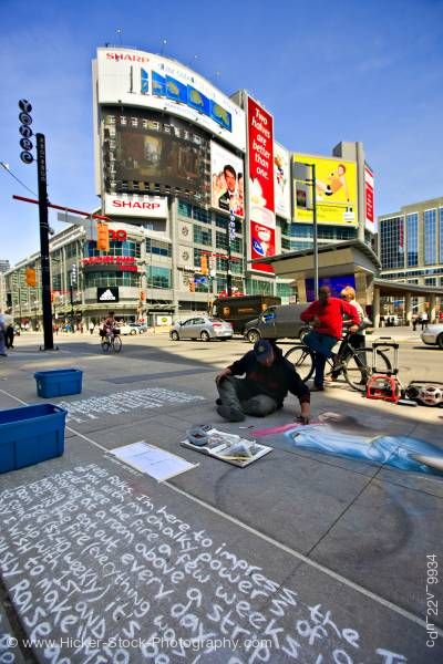 Stock photo of Chalk Artist on Pavement Buildings and Blue Sky in Downtown Toronto Ontario Canada 