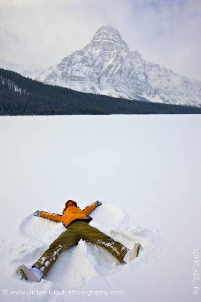 Stock photo of Woman Making Snow Angel on Waterfowl Lake Mount Chephren Icefields Parkway Banff National Park