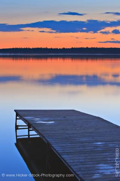 Stock photo of Golden sunset wooden wharf Lake Audy Riding Mountain National Park Manitoba Canada